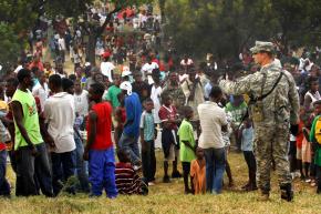 A U.S. soldier monitors a crowd of people waiting for aid in Haiti