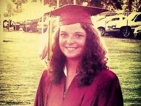 Chelsey Ramer wearing her graduation cap and eagle feather